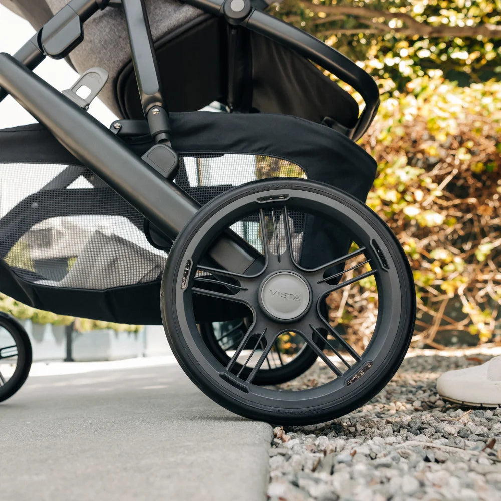 UPPAbaby Vista V3 stroller rear wheel close-up showing all-terrain wheel design.
