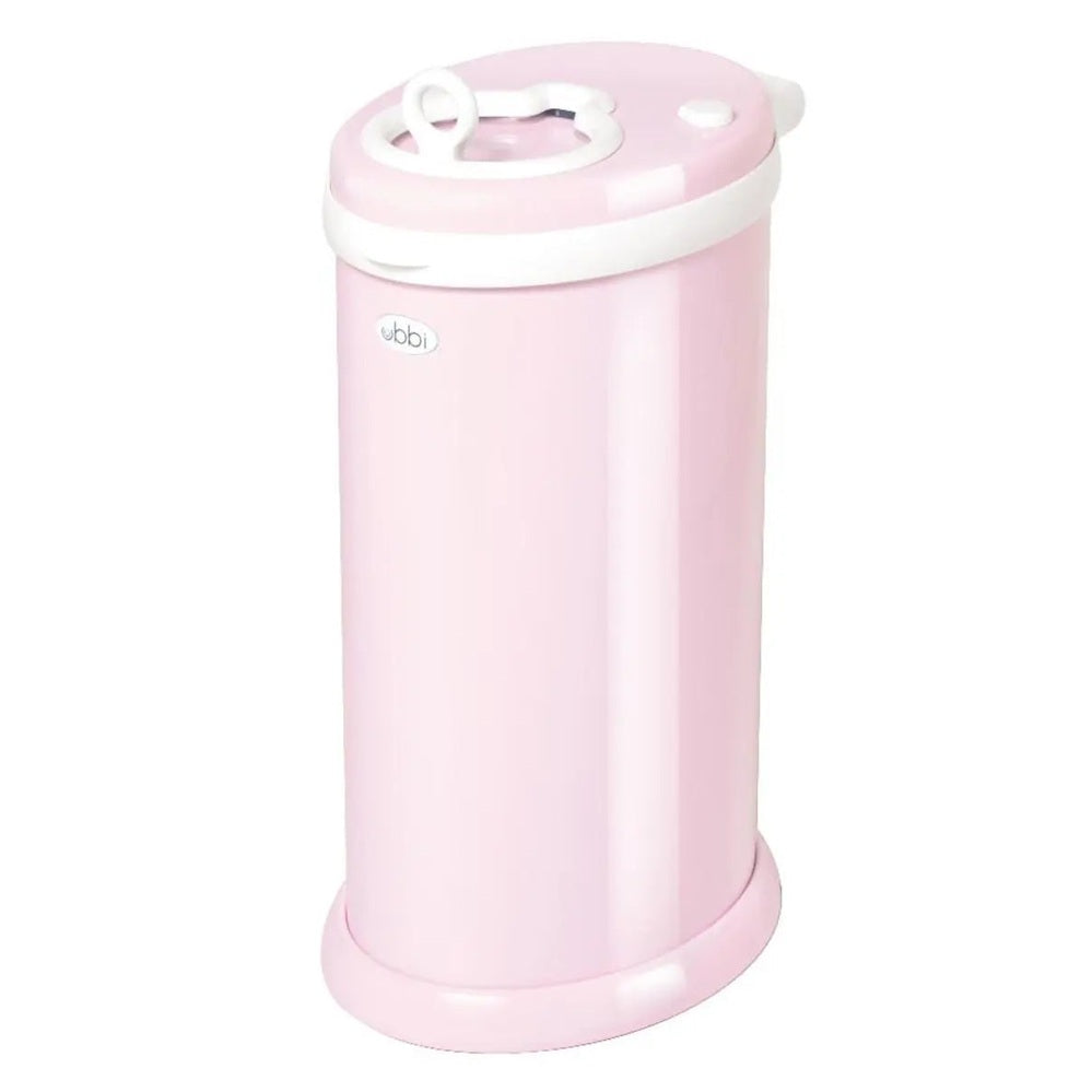 Ubbi Ubbi Diaper Pail in pastel pink with white lid, standing upright with lid closed.