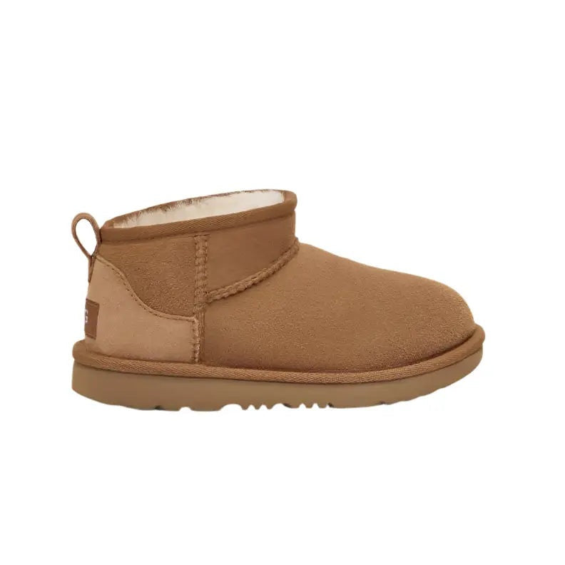 UGG Kid's Classic Ultra Mini Chestnut boot in tan suede with shearling lining; back pull-tab and rugged sole.