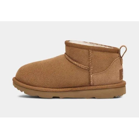 UGG Kid's Classic Ultra Mini Chestnut boot in side view, showing suede exterior and plush sheepskin lining.