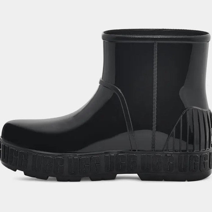 UGG Kid's Drizlita Black rubber rain boot with glossy finish, chunky sole, and fringe at heel.