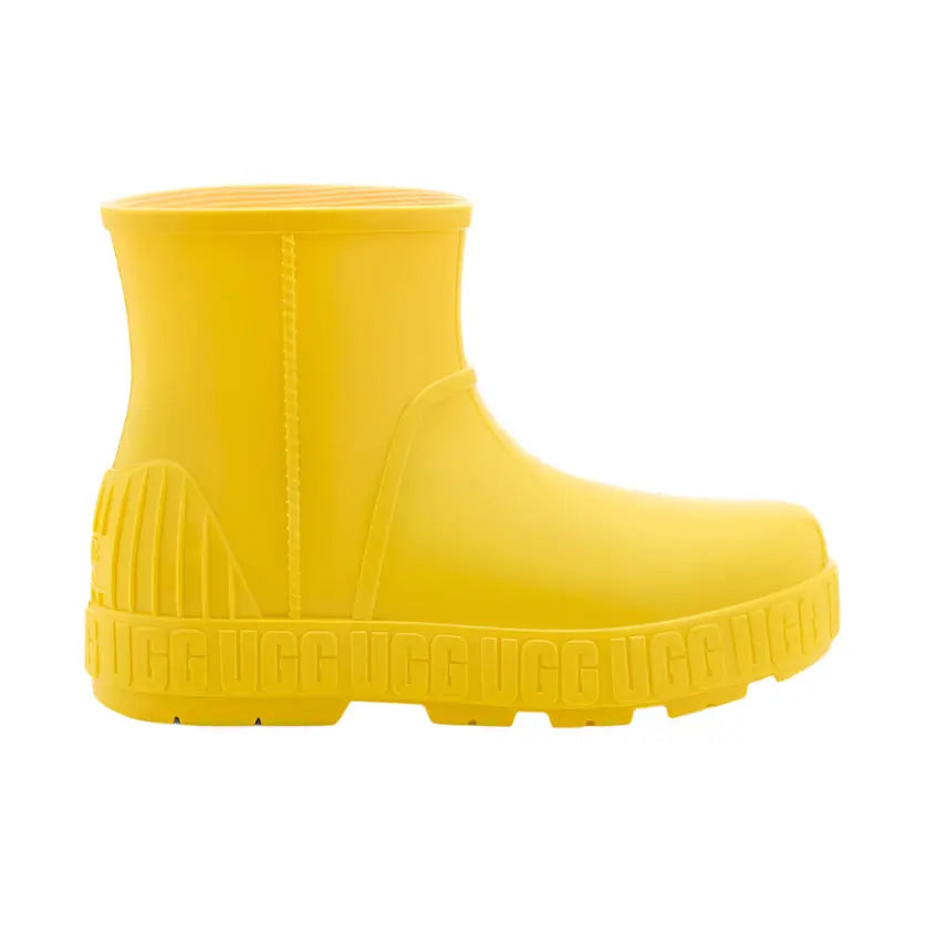 UGG Kids Drizlita Canary rain boot in bright yellow rubber, side view showing chunky tread sole.