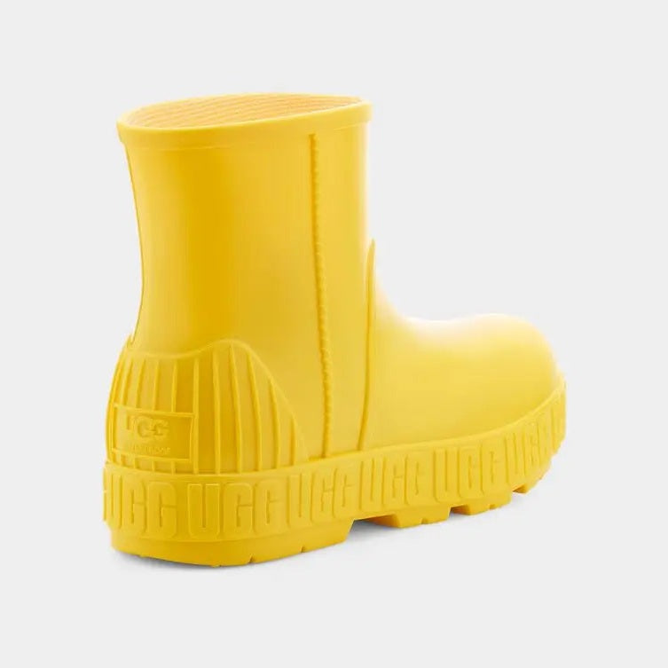 UGG Kid's Drizlita Canary yellow rubber boot, chunky sole shown with textured tread and back pull tab.