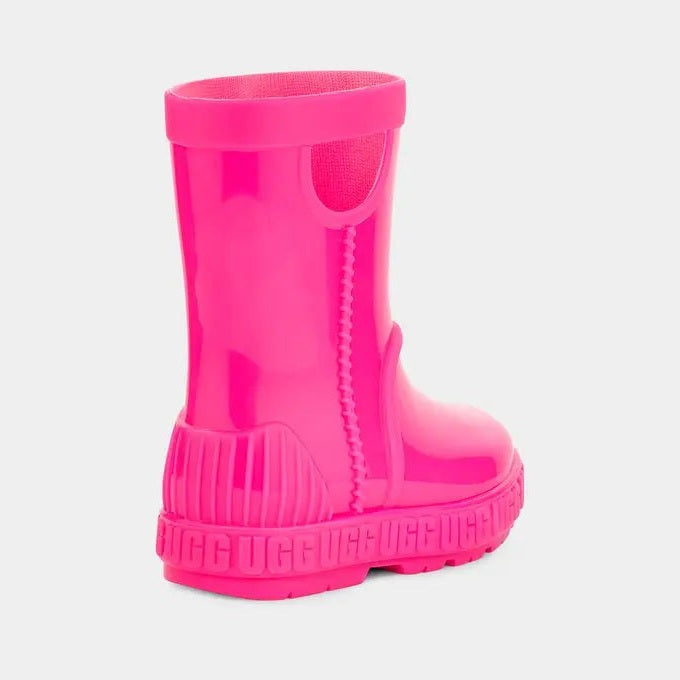 UGG Toddler Drizlita Taffy Pink rain boot; bright pink rubber, chunky sole, back heel grip, worn by toddler.
