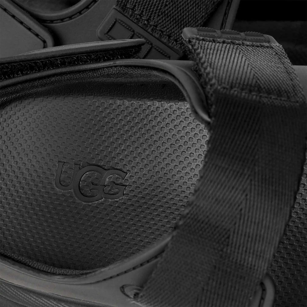 UGG Goldenglow women's sandals in black with textured strap and visible logo.