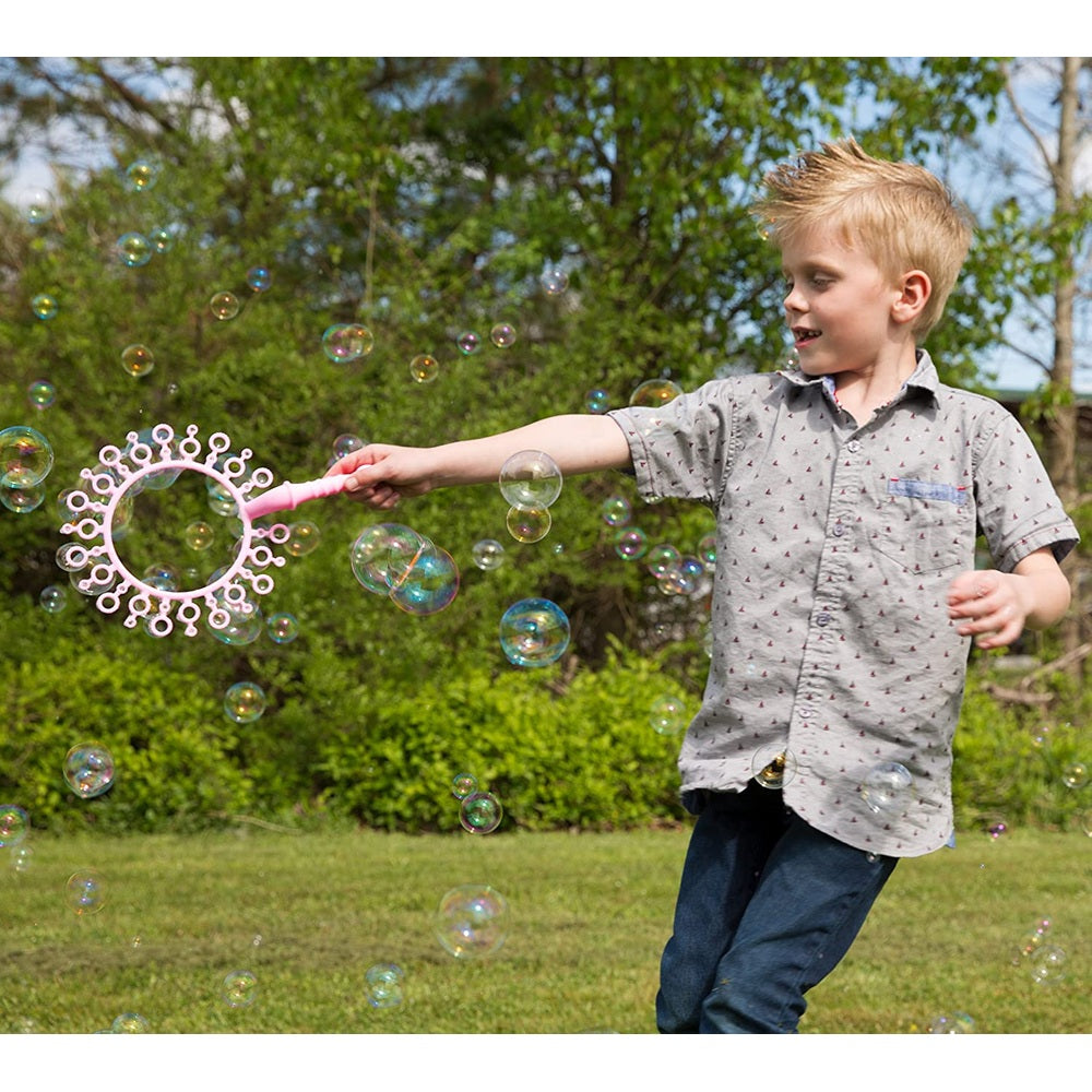 Uncle Bubble Fun Fantasy Wand 4 oz bubble toy with pink handle and circular wand frame; child playing