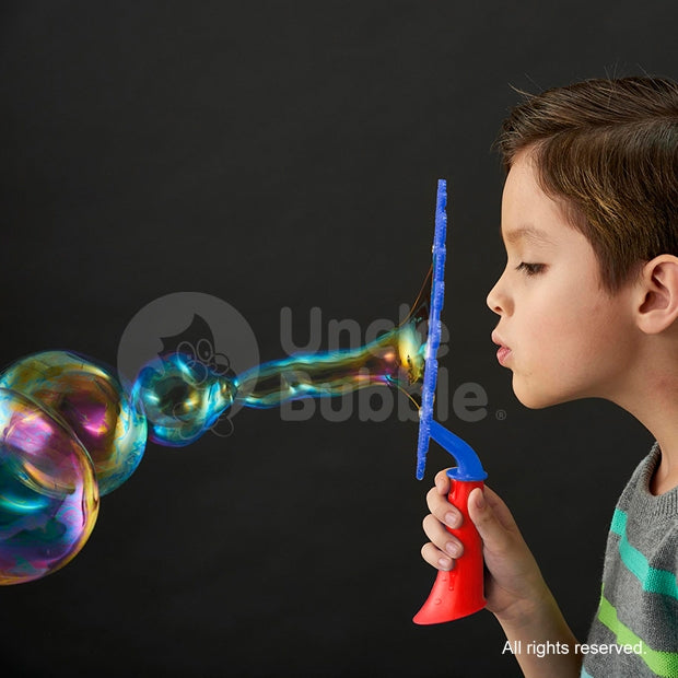 Uncle Bubble Game Bubble Tricks Starter Kit; child blowing iridescent bubbles with blue wand and red handle