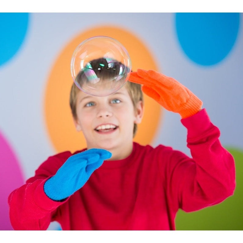 Uncle Bubble Ultra Bouncing Bubble toy; boy in red shirt and blue/orange gloves blowing a bubble.