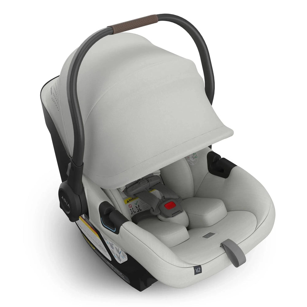 Uppababy Aria V2 Car Seat in Light Gray with brown grip handle
