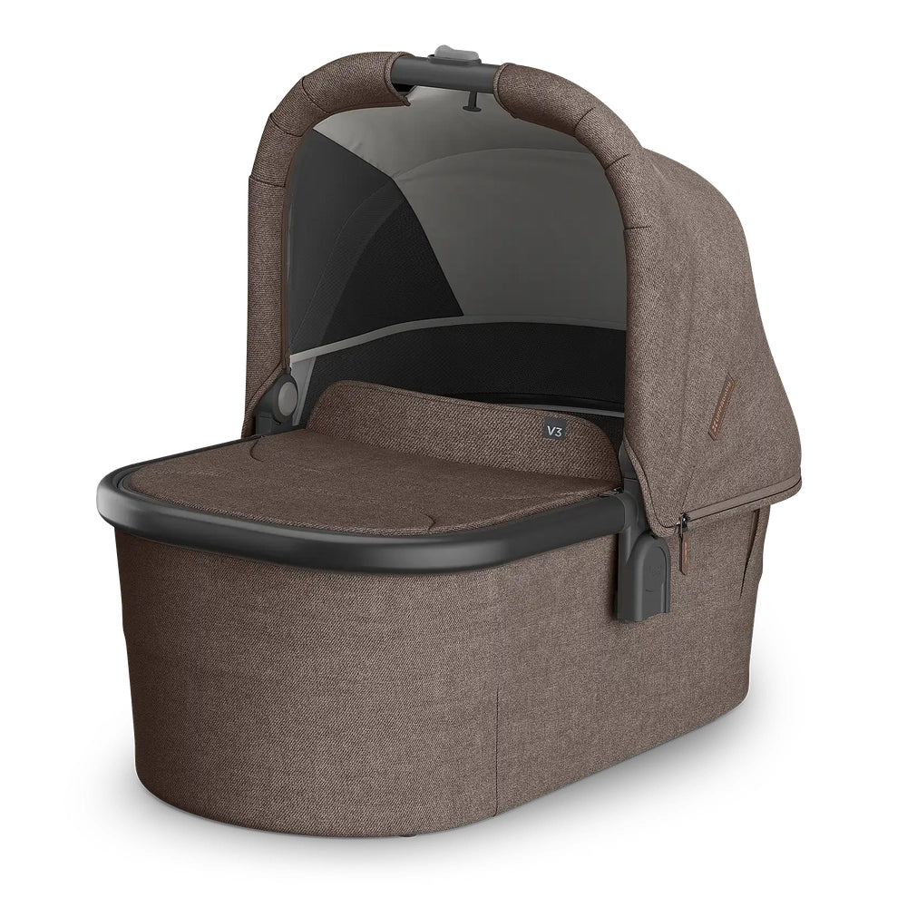 Uppababy Bassinet V3 in brown textured fabric with canopy, carry handle, and side zipper.