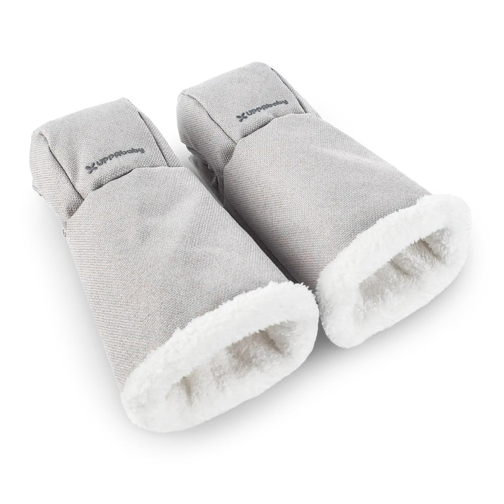 Uppababy Cozy Handmuffs in light gray fabric with white fleece lining, two mitts shown ready to snap onto stroller handles.