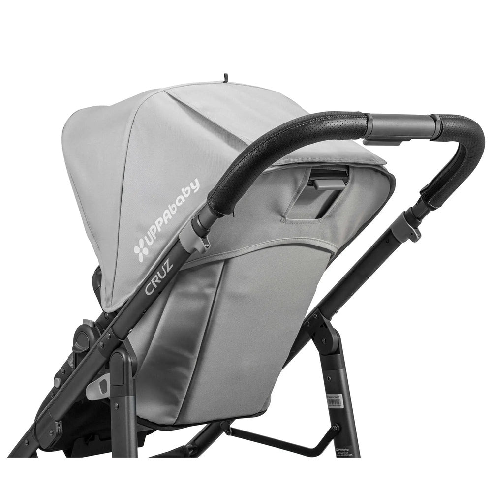 Uppababy Cruz Leather Handle Bar Cover on gray stroller, featuring textured black grip and snug fit.