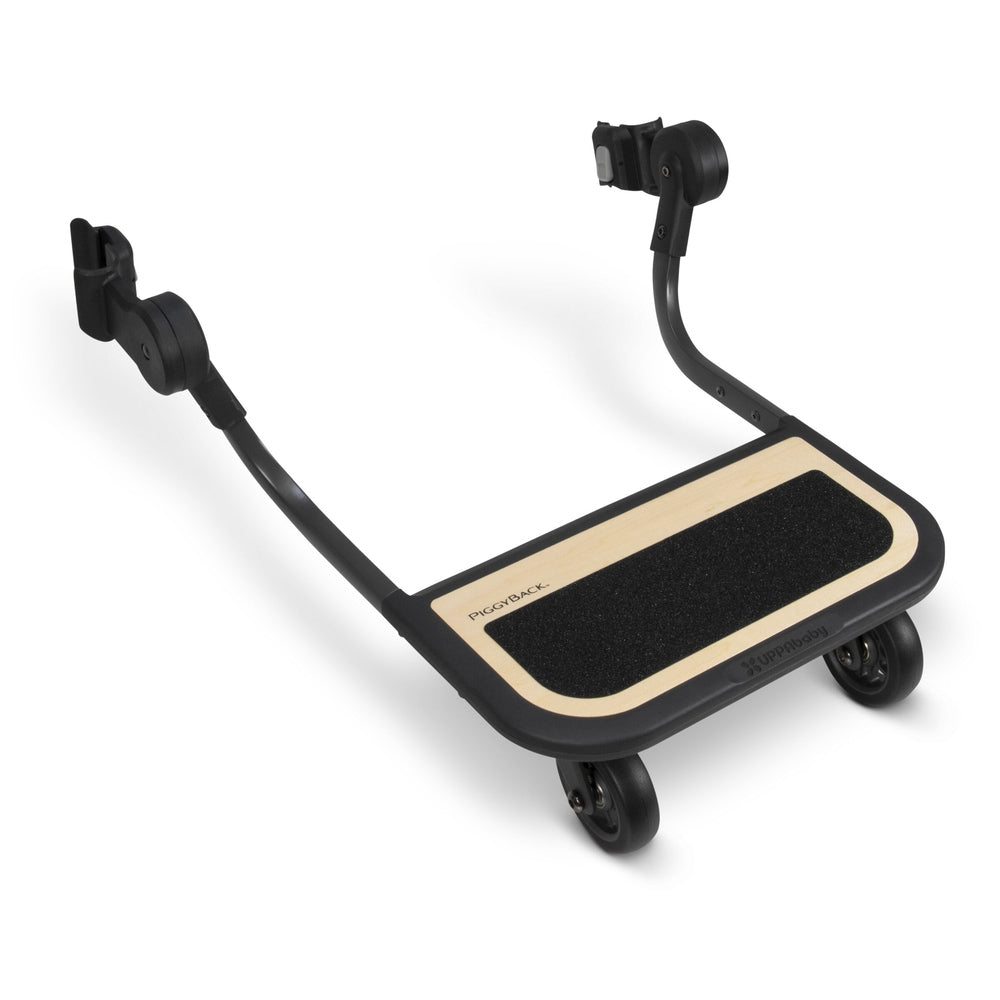 Uppababy Cruz V2 Piggyback ride-along board with wood-toned footboard and black frame.