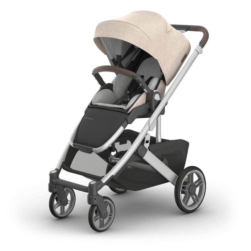 Uppababy Cruz V3 stroller in beige fabric with grey seat, silver frame and sun canopy.