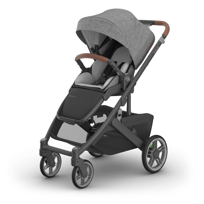 Uppababy Cruz V3 stroller in gray fabric with brown leatherette handle and canopy setup.