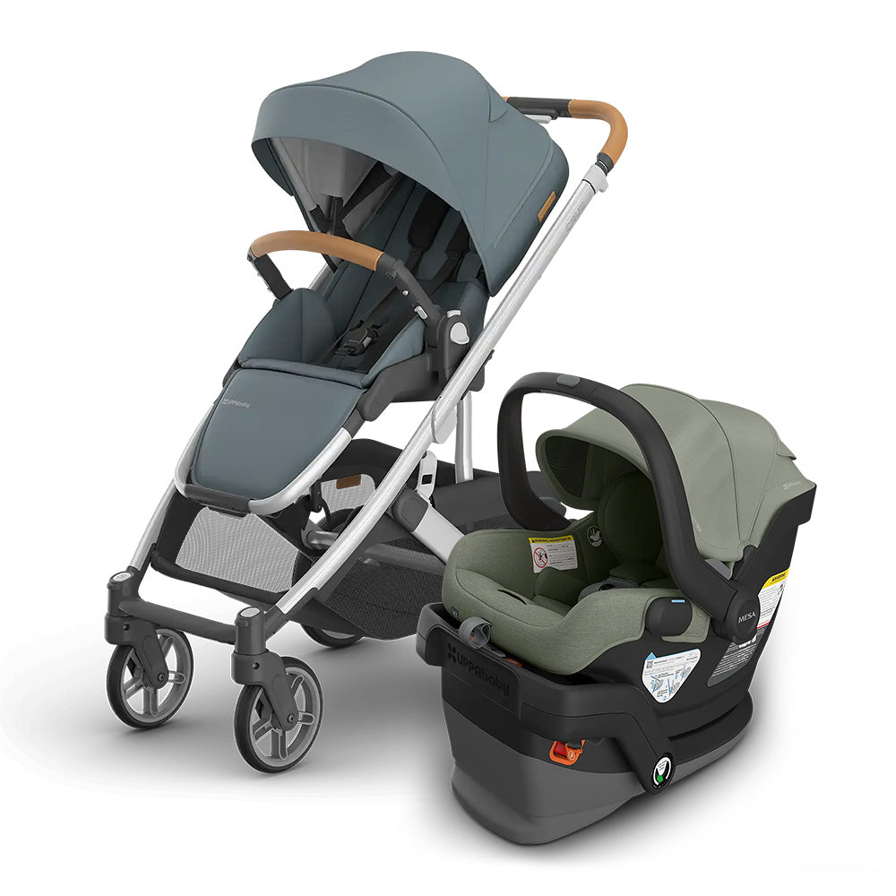 UPPAbaby Cruz V3 Stroller + Mesa V3 Infant Car Seat Travel System in blue-gray stroller with an olive car seat, ready for travel.