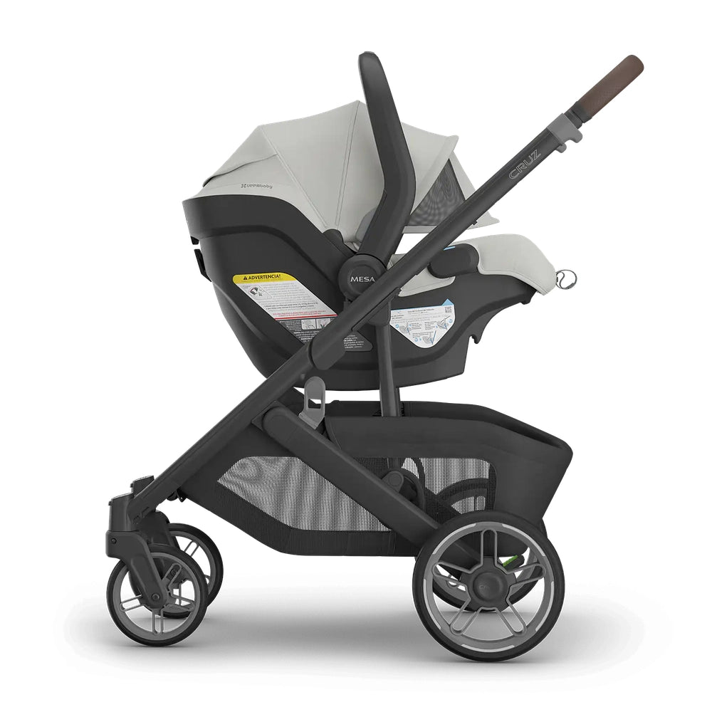 UPPAbaby Cruz V3 Stroller + Mesa V3 Infant Car Seat Travel System with a car seat attached to a sleek black/gray stroller.