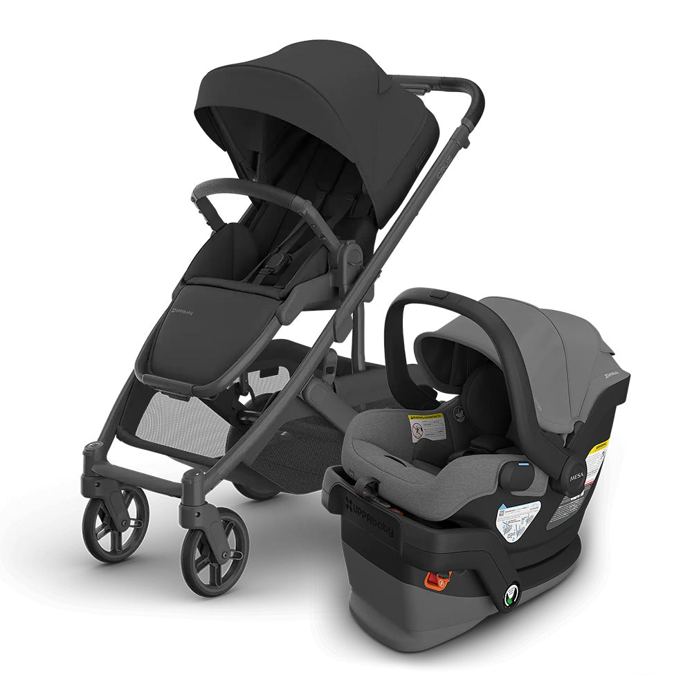UPPABABY Cruz V3 Stroller + Mesa V3 Infant Car Seat Travel System in charcoal, stroller with canopy beside the car seat.