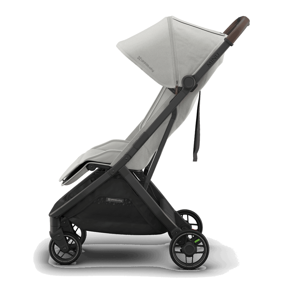 Uppababy Minu V3 stroller in light gray fabric, black frame, and brown leather-style handle.