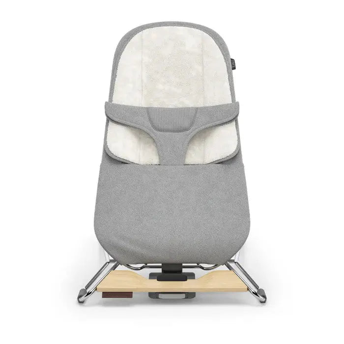 Uppababy Mira 2-in-1 baby bouncer and seat in gray fabric, standing on a wooden base with metal rockers.