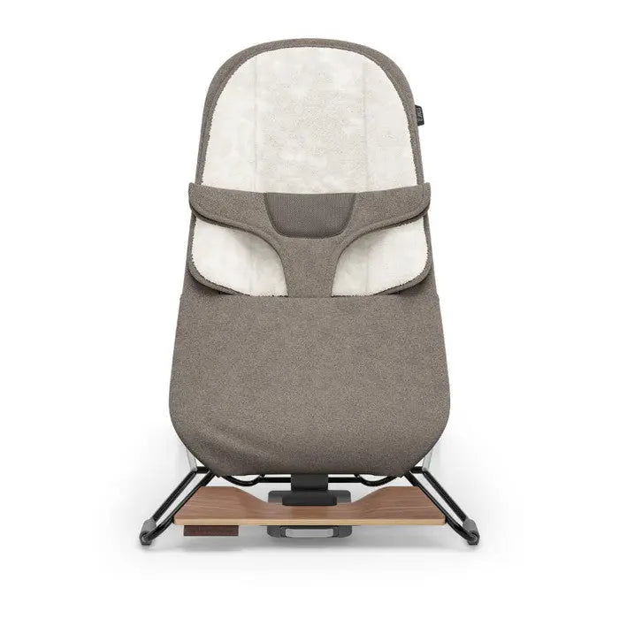 Uppababy Mira 2-In-1 Bouncer and Seat in taupe fabric with wooden base and frame.
