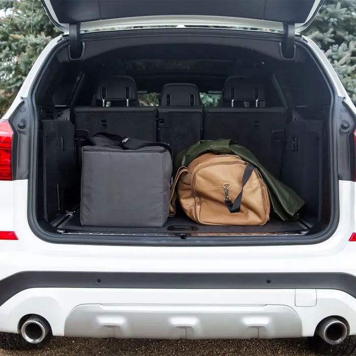 Uppababy Remi Travel Bag in gray with brown duffel in SUV trunk