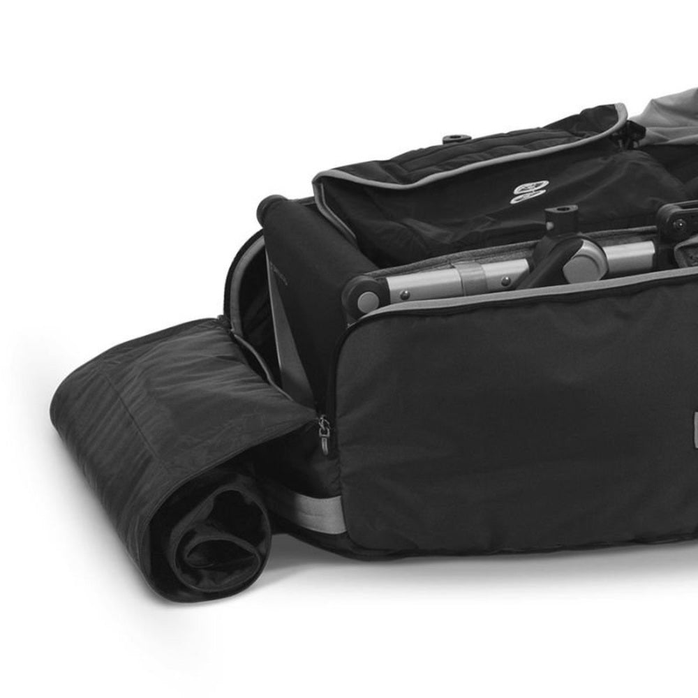 Uppababy travel bag for Vista and Cruz strollers with rolled mat accessory, black with silver hardware.