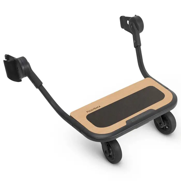 Uppababy Vista Piggyback Ride-Along Board with tan deck and black grip pad, dual wheels.