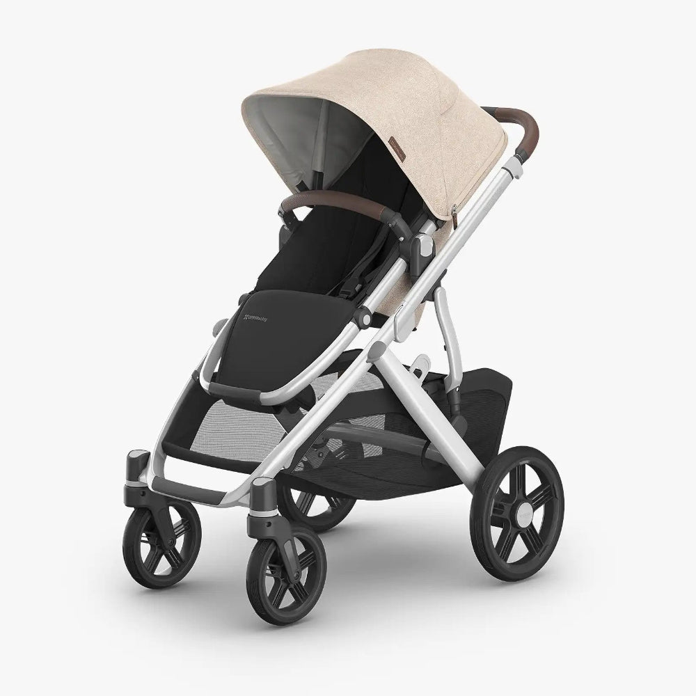 Uppababy Vista V3 stroller with beige canopy and black seat, silver frame; front wheels turned and awaiting push.