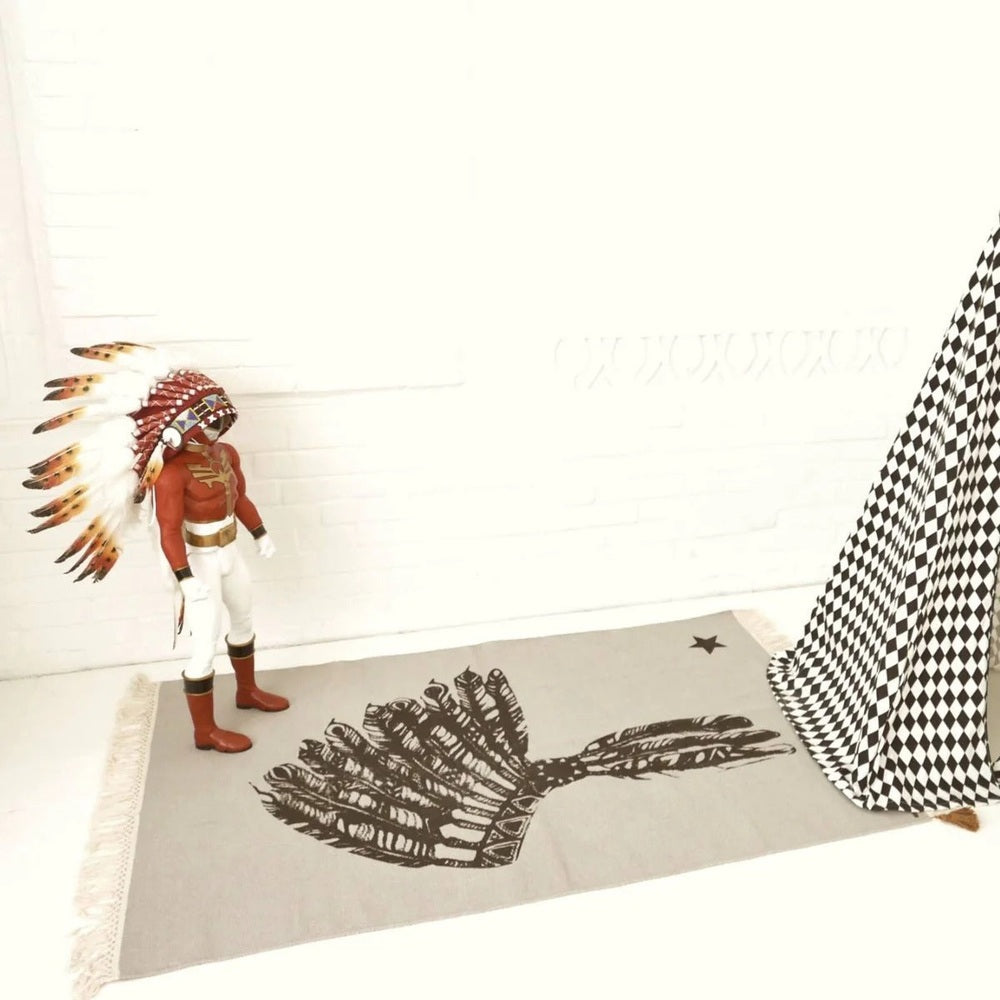 Varanassi dhurrie rug and Native American chief figurine with feather headdress; grey rug with black feather motif
