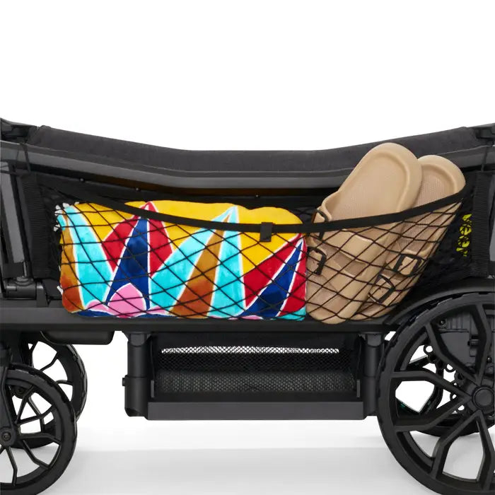 Veer Cargo Net on stroller with a colorful geometric towel and beige sandals