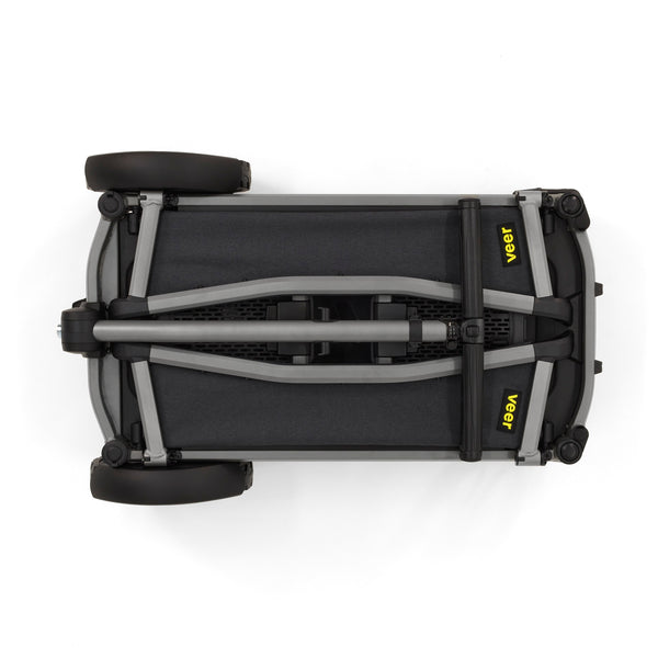 Veer City Cruiser Wagon folded; black fabric body with gray aluminum frame and yellow VEER logos