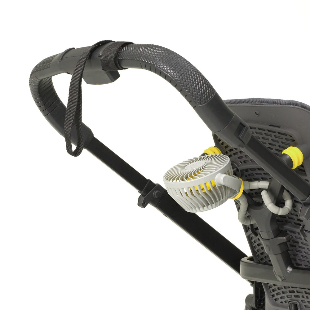 Veer Flex Fan mounted on stroller handle; compact white portable fan with yellow accents and black frame