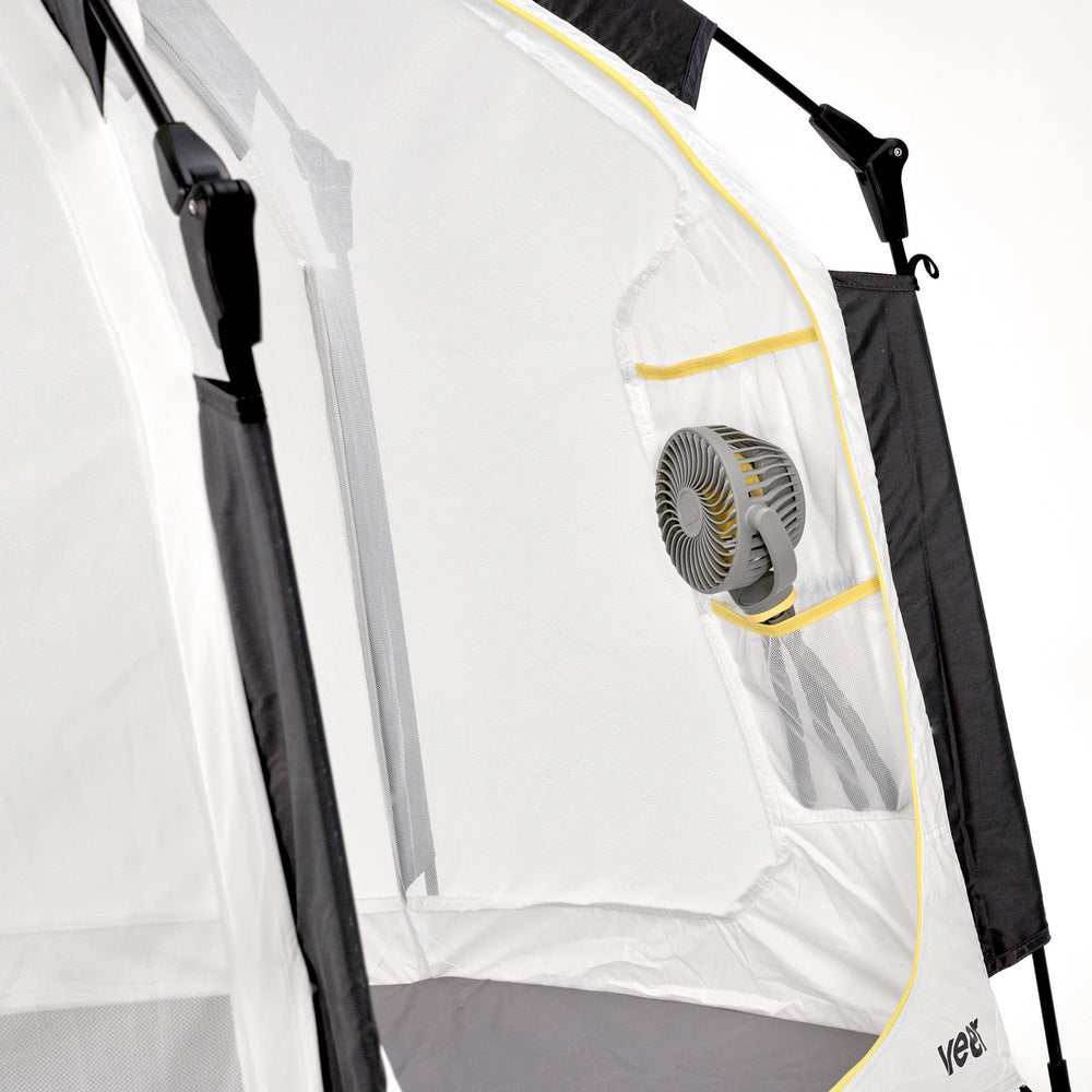 Veer Flex Fan inside white baby travel tent with yellow trim; gray clip-on fan by VEER