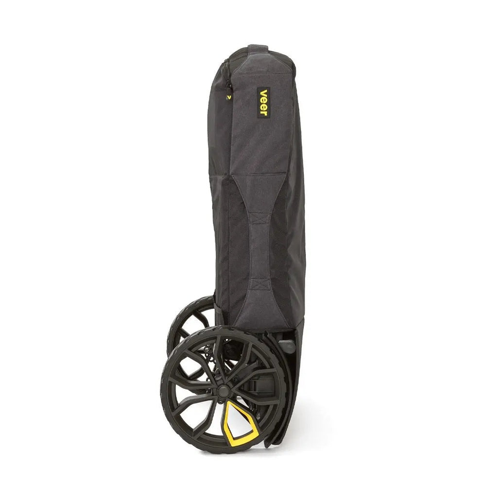Veer Travel Bag in dark gray fabric with built-in wheels, showing easy rolling for stroller travel.