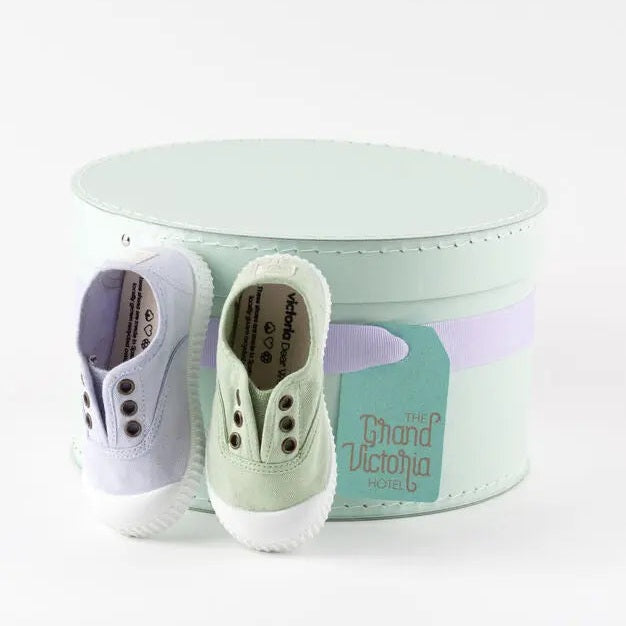 Victoria Shoes Rubber Toecap Canvas Tin Wasabi, two lavender and wasabi sneakers beside a mint tin.