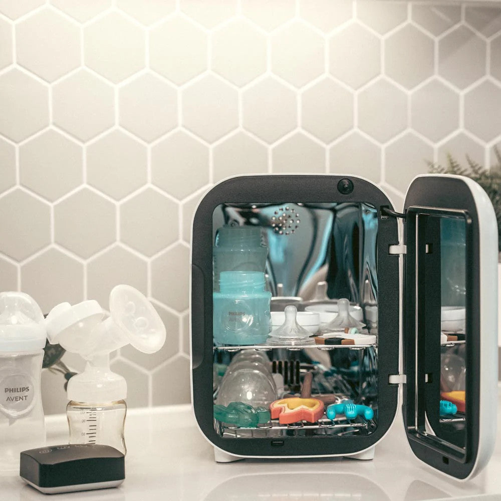 Wabibaby UVC LED Mini Sterilizer and Dryer with open door and baby bottles inside on a kitchen counter