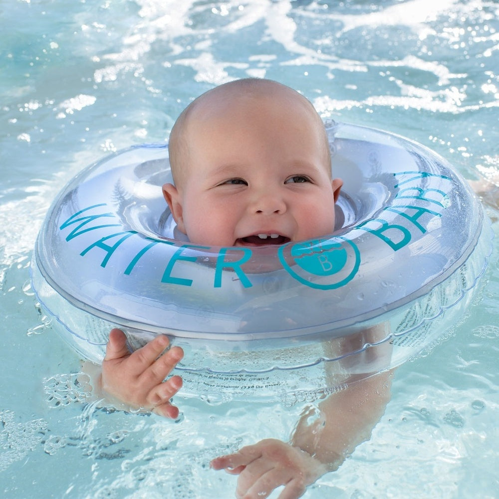 Water Baby Floatie neck ring for infants in clear blue, baby smiles while floating in pool with logo visible.