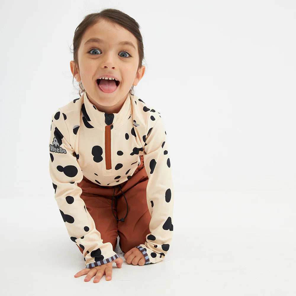 Weedo Puppydo Thermoshirt in cream Dalmatian spots with a brown zipper, worn by a happy toddler crawling.