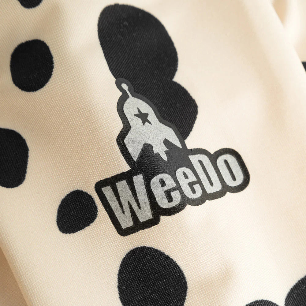 Weedo Puppydo Thermoshirt baby top in beige with black polka dots and a rocket logo graphic visible on the chest.