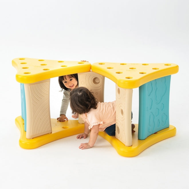 Weplay Over The Mountain play structure, yellow and blue with beige panels, two kids crawling through openings