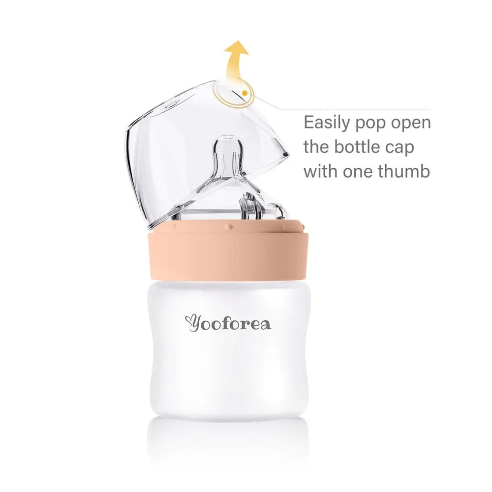 Yooforea Silicone Coated Glass Baby Bottle 3oz/90ml, peach cap, shown being opened with one thumb.