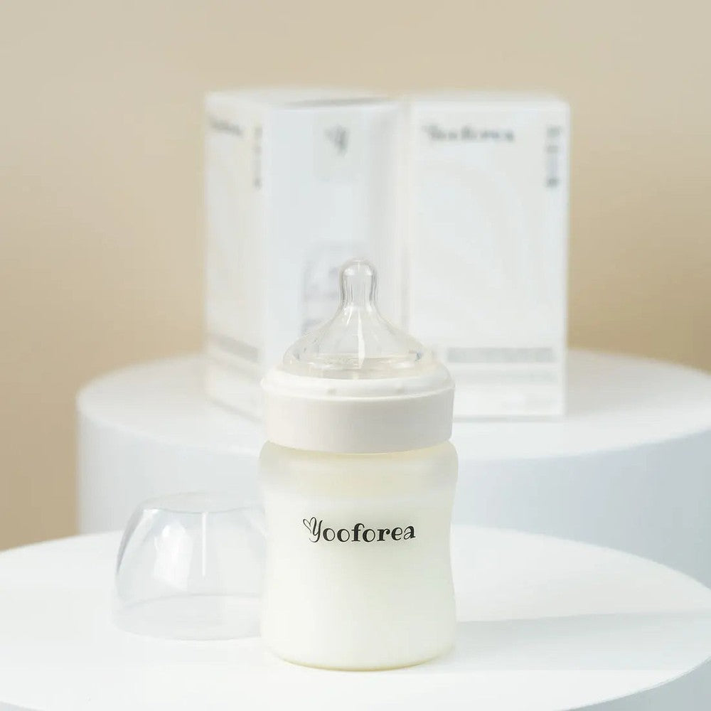 Yooforea silicone-coated glass baby bottle 5oz/150ml with clear nipple, ready for feeding on a white surface.