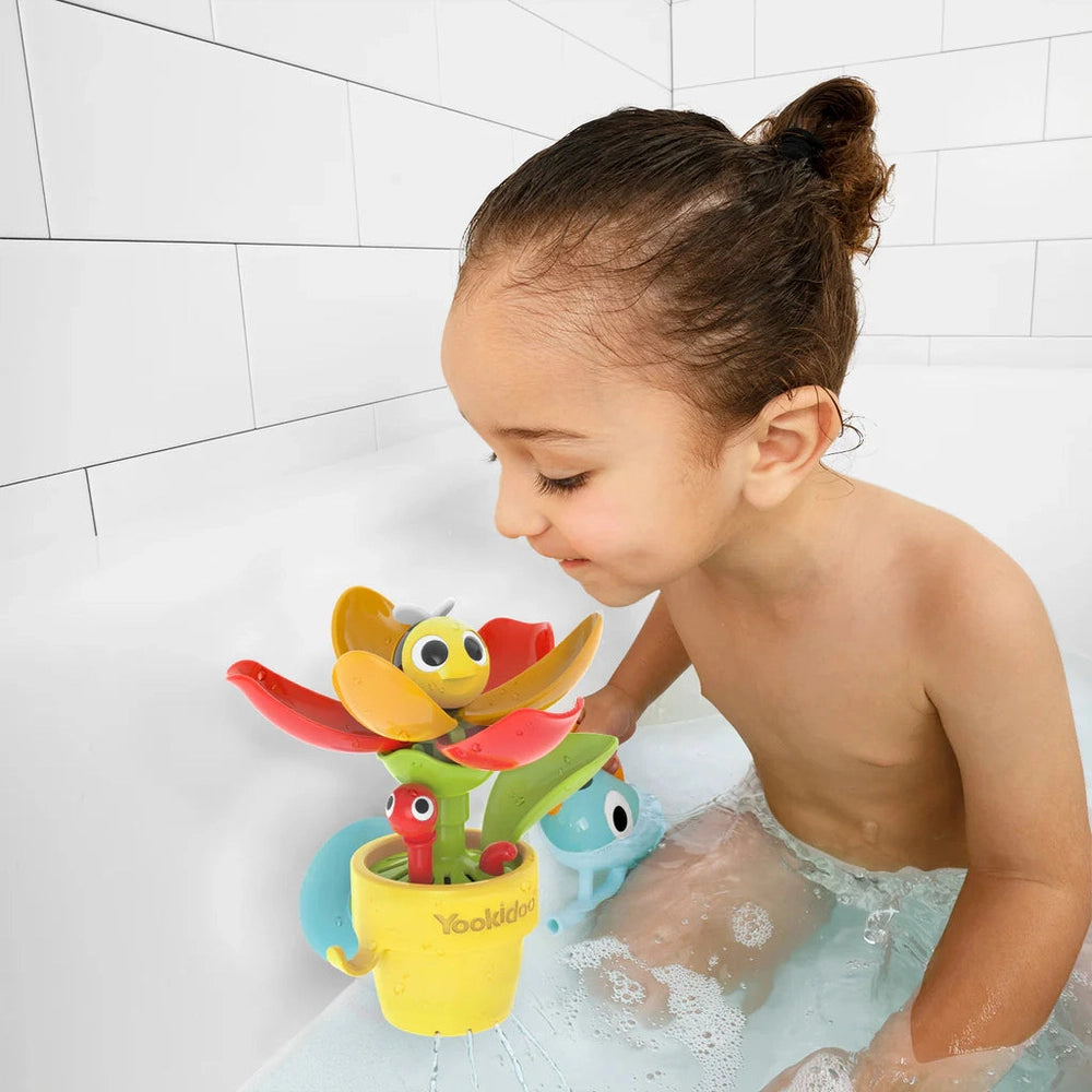 Yookidoo Peek-A-Bee Flower Tub bath toy with a yellow pot and colorful petals as a child plays in the tub.