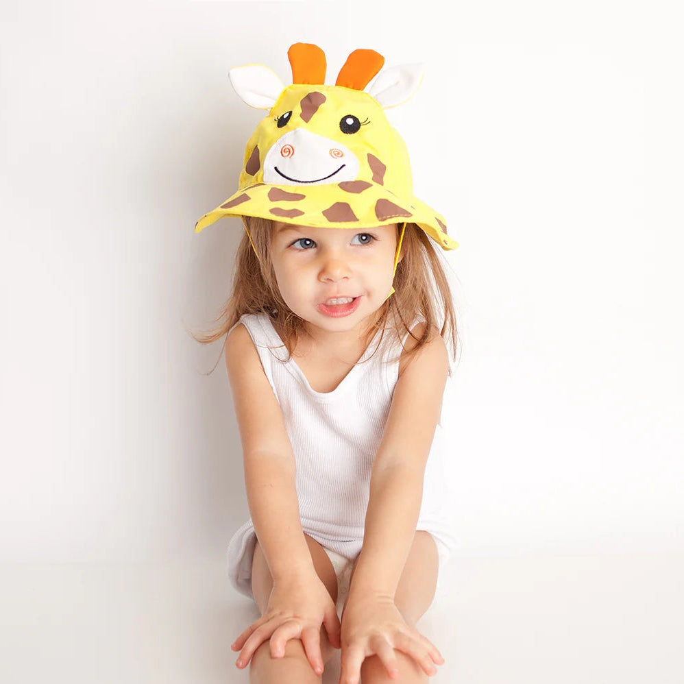 Zoocchini giraffe sun hat for babies/toddlers, yellow with giraffe print and ears on a smiling child