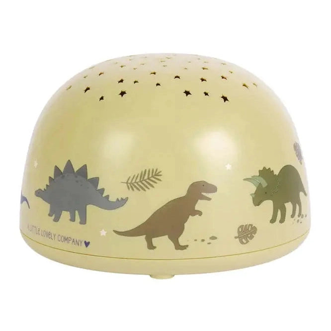 A Little Lovely Company Projector Night Light in pale yellow, dome with dinosaur silhouettes and star cutouts projecting a soothing glow.