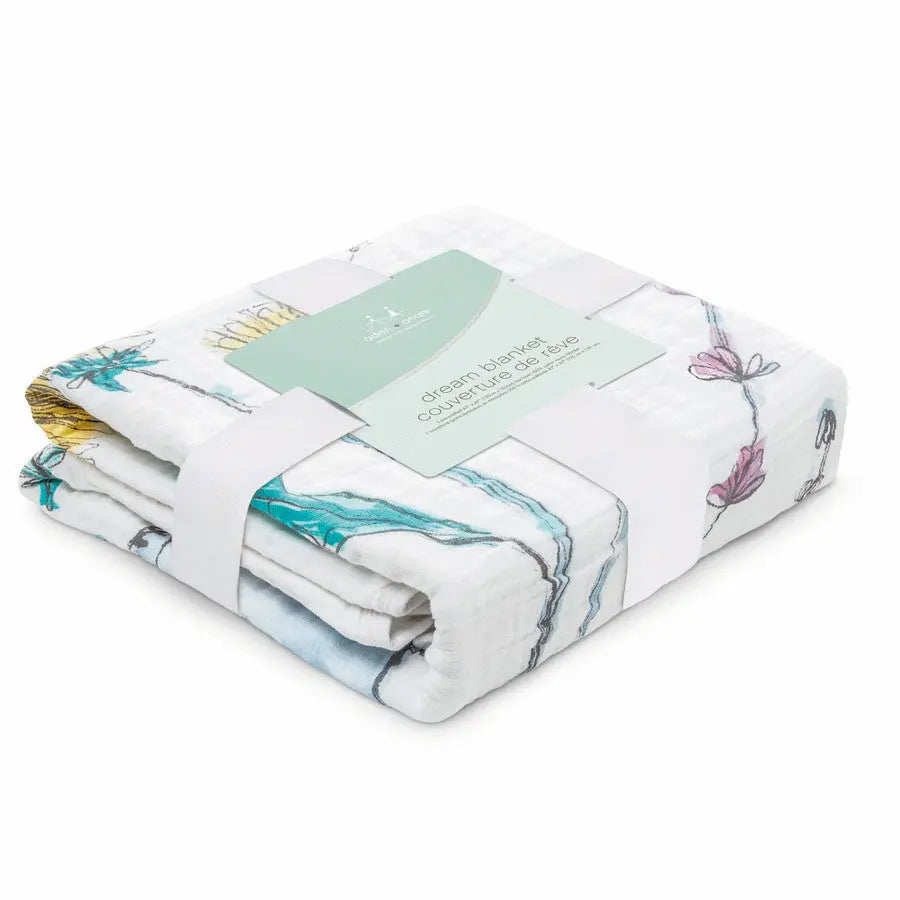 Aden+Anais Classic Dream Blanket folded neatly, white muslin with pastel floral print and tag.