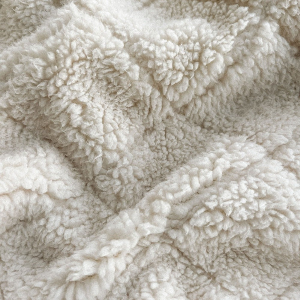Aden+Anais Embrace Morris Vine weighted toddler blanket in plush cream sherpa fabric.