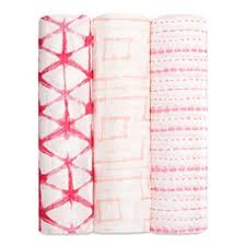 ADEN+ANAIS Silky Soft Stroller Blanket Berryshibori 3-pack, three pink shibori blankets neatly rolled upright.