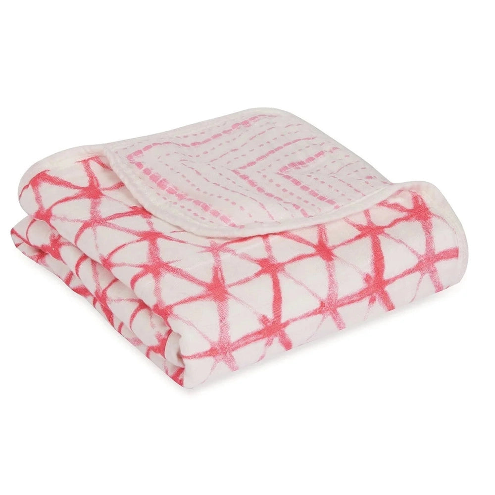 ADEN+ANAIS Silky Soft Stroller Blanket Berry Shibori folded for cozy, pink and white tie-dye blanket.